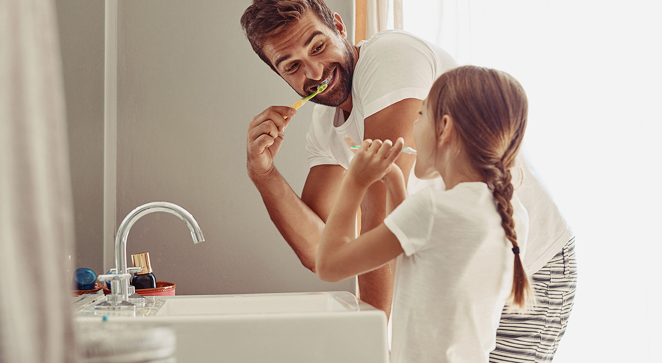 Family brushing their teeth